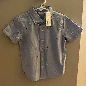 Never worn boys size 6 light blue, nautical flag button up short sleeved shirt.